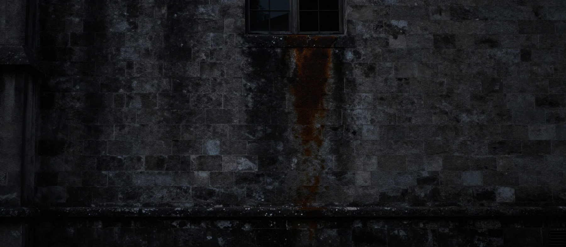 An old stone façade in shadow